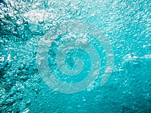 Bubbles in tropical sea. Underwater turquoise texture in ocean