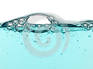 Bubbles in turquoise liquid soap