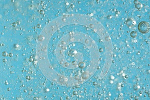 Bubbles in the water on a blue background. Closeup.