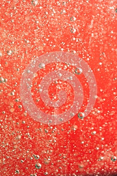 Bubbles of water on a red background closeup.