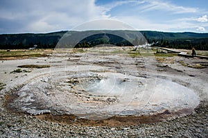 Bubbling and erupting geyser hot spring inside of Yellowstone National Park at the Biscuit Basin area