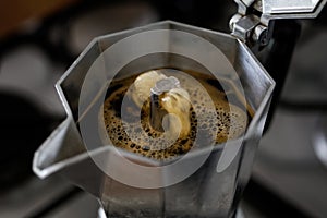 Bubbling espresso coffee in a stovetop moka express.