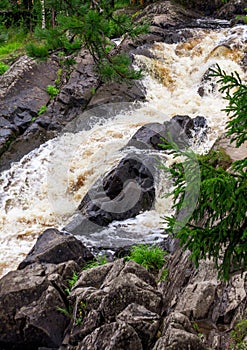 a bubbling fast cold river with cliffs and waterfalls, a mountain river with rapids