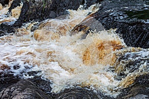 a bubbling fast cold river with cliffs and waterfalls, a mountain river