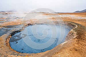 Bubbling geothermal hot/mud pool in the Hverarond area near Myvatn in the Icelandic landscape.
