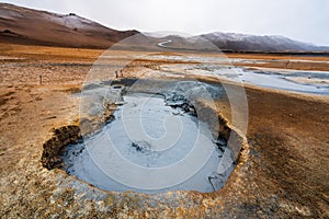Bubbling geothermal hot/mud pool in the Hverarond area near Myvatn in the Icelandic landscape. photo