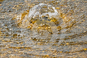 Bubbling golden water - spa concept photo