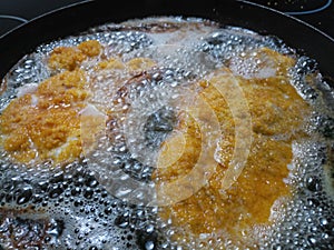 Bubbling hot weiner schnitzel in a hot pan