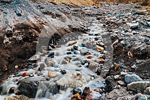 A bubbling mountain stream. The flow of water among the rocks. A long exposure.