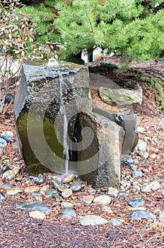 A bubbling water fountain in a garden