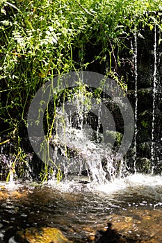 Bubbling water and stones. Cascade falls. Background texture