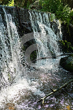 Bubbling water and stones. Cascade falls. Background texture