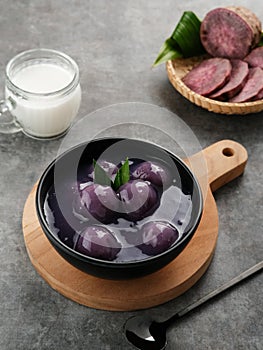 Bubur candil or Candil porridge is porridge made from purple sweet potato cooked with coconut milk, sugar and pandan leaves. photo