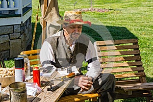 A Male Reenactor With a Hat Relaxing at the Confederate Encampment