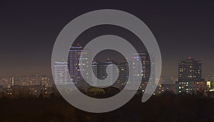 Bucharest city skyline at night with skyscrapers