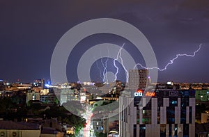 Bucharest heavy rain and thunder storm , lightning strike over the city, night cityscape