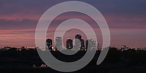 Bucharest night city skyline panorama in Romania capital, with tall buildings and pink, purple twilight colors