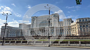 Bucharest, Robucharest, Romania Palace of the Parliament Boulevard full of trees to Parliament cars moving on empty road