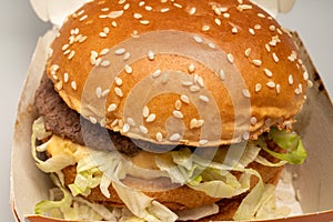 Bucharest, Romania - 01.28.2023: closeup of sloppy assembled or cooked Bigmac burger taken away from McDonalds restaurant