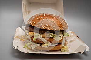 Bucharest, Romania - 01.28.2023: closeup of sloppy assembled or cooked Bigmac burger taken away from McDonalds restaurant
