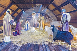 Bucharest, Romania - December 25, 2017: Christmas scene with three wise men presenting gifts to baby Jesus, Mary & Joseph