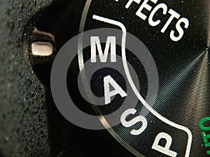 Bucharest / Romania - July 24, 2019: Macro of a Nikon DSLR camera mode dial turned on manual mode