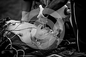 Paramedics perform CPR to a plastic dummy during a public demonstration on how to save a victim