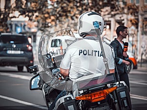 Traffic policeman on motorbike. Police officer control in the center of Bucharest