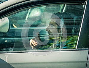 Bucharest/Romania - 10.17.2020: Man smoking in his car while driving