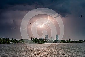 Lightning storm over the city in summer time Romania heavy rain