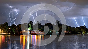 Bucharest summer lightning storm in Herastrau lake photo