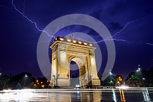 Bucharest Triumph Arch in the light storm by night