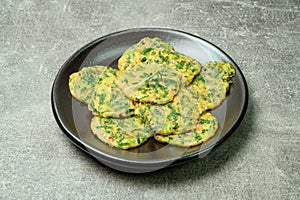 buchujeon, korean Chive Pancake, To prepare this dish, chive, julienned carrot, and green pepper are mixed with flour and pan-