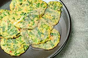 buchujeon, korean Chive Pancake, To prepare this dish, chive, julienned carrot, and green pepper are mixed with flour and pan-