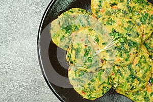 buchujeon, korean Chive Pancake, To prepare this dish, chive, julienned carrot, and green pepper are mixed with flour and pan-