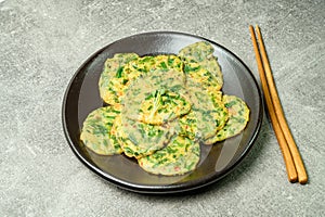 buchujeon, korean Chive Pancake, To prepare this dish, chive, julienned carrot, and green pepper are mixed with flour and pan-