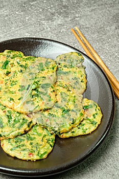 buchujeon, korean Chive Pancake, To prepare this dish, chive, julienned carrot, and green pepper are mixed with flour and pan-