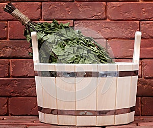 Bucket for a bath on a brick surface.