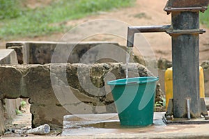 Bucket being filled at African well.