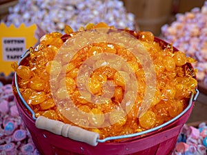Bucket of butterscotch surrounded by a variety of other candy