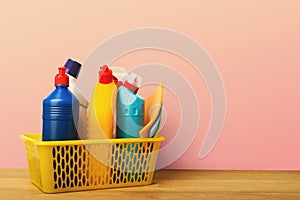 Bucket with cleaning items on table