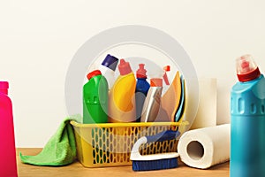 Bucket with cleaning items on table