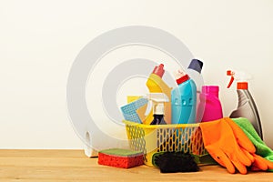 Bucket with cleaning items on table