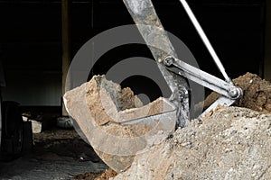 Bucket excavator digs soil at construction site