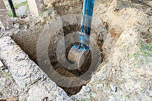 Bucket excavator digs soil at construction site