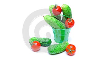 Bucket of freshly picked cucumbers and tomatoes