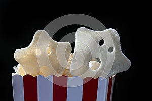 Bucket of Halloween scary ghost chips, various Halloween horror ghost in paper box with dark background