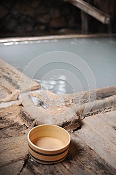 Bucket at indoor hot spring bath at Nyuto Onsen hot spring in green mountain valley in Semboku city, Akita Japan