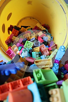 A bucket of Scattered Legos on the Floor