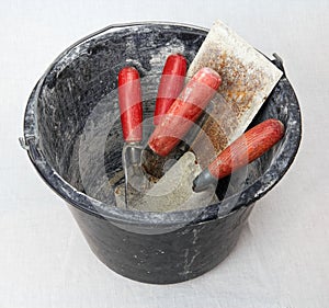 Bucket with masonry tools